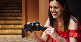 Canon EOS R10 being held by a woman