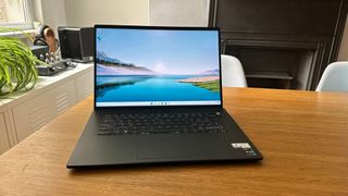 An open Dell Inspiron 16 Plus 7620 sitting on a wooden table