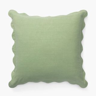 light green square cushion with scalloped edges