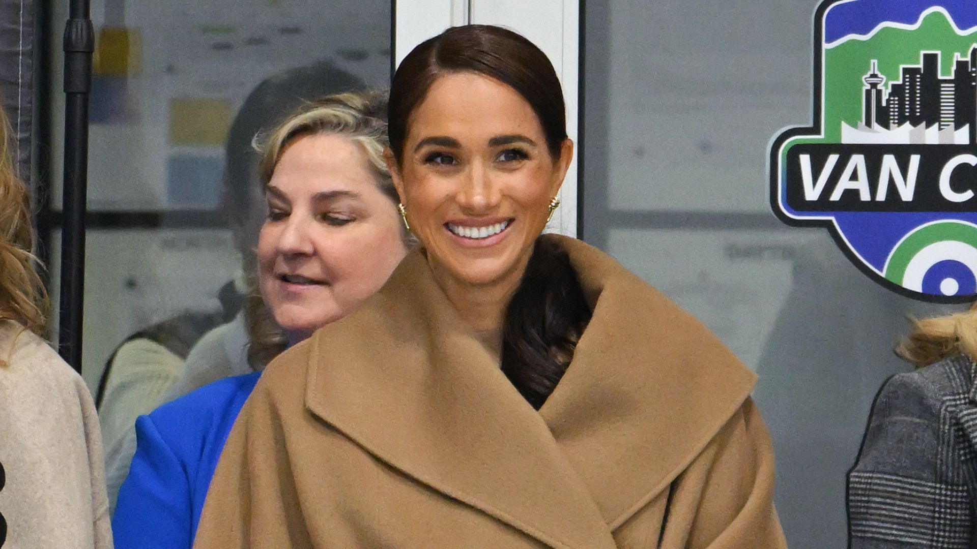 Meghan Markle Combines the Sleeveless Turtleneck and Trench Coat Trends for an Australia Outing With Prince Harry