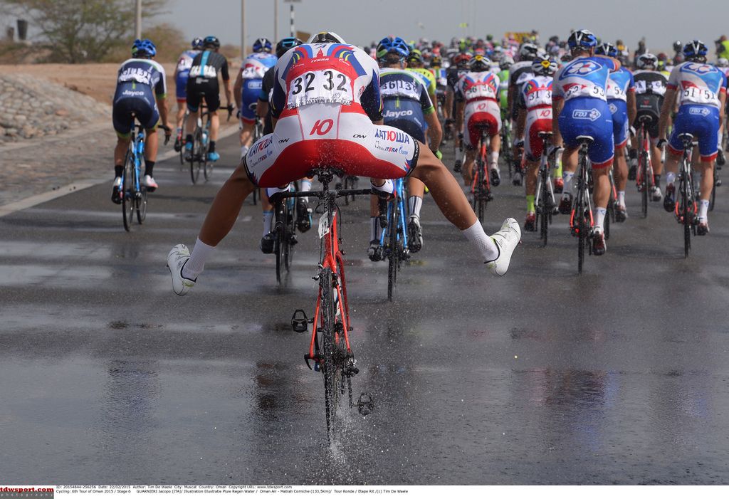 A Katusha rider tries to avoid getting wet feet