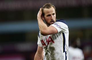 Tottenham striker Harry Kane sweeps his hair off his face
