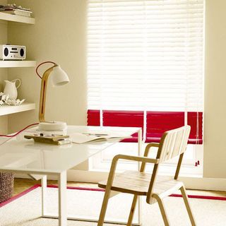 white walls with carpet on flooring and table with chair