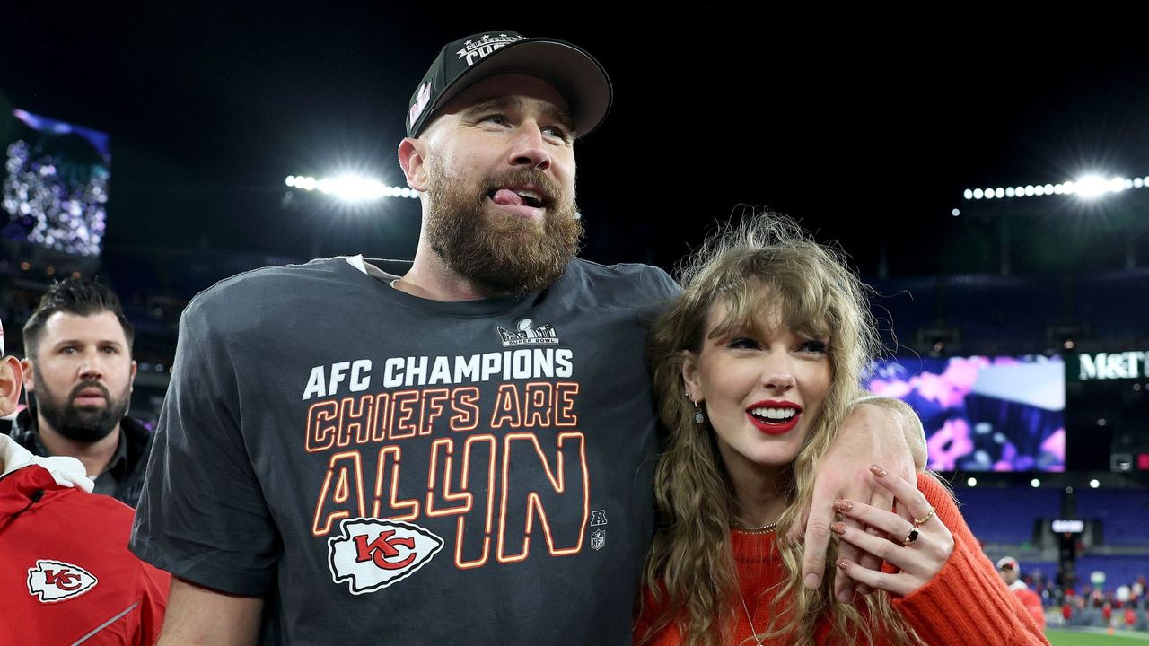 Travis Kelce and Taylor Swift smile together at the AFC Championship