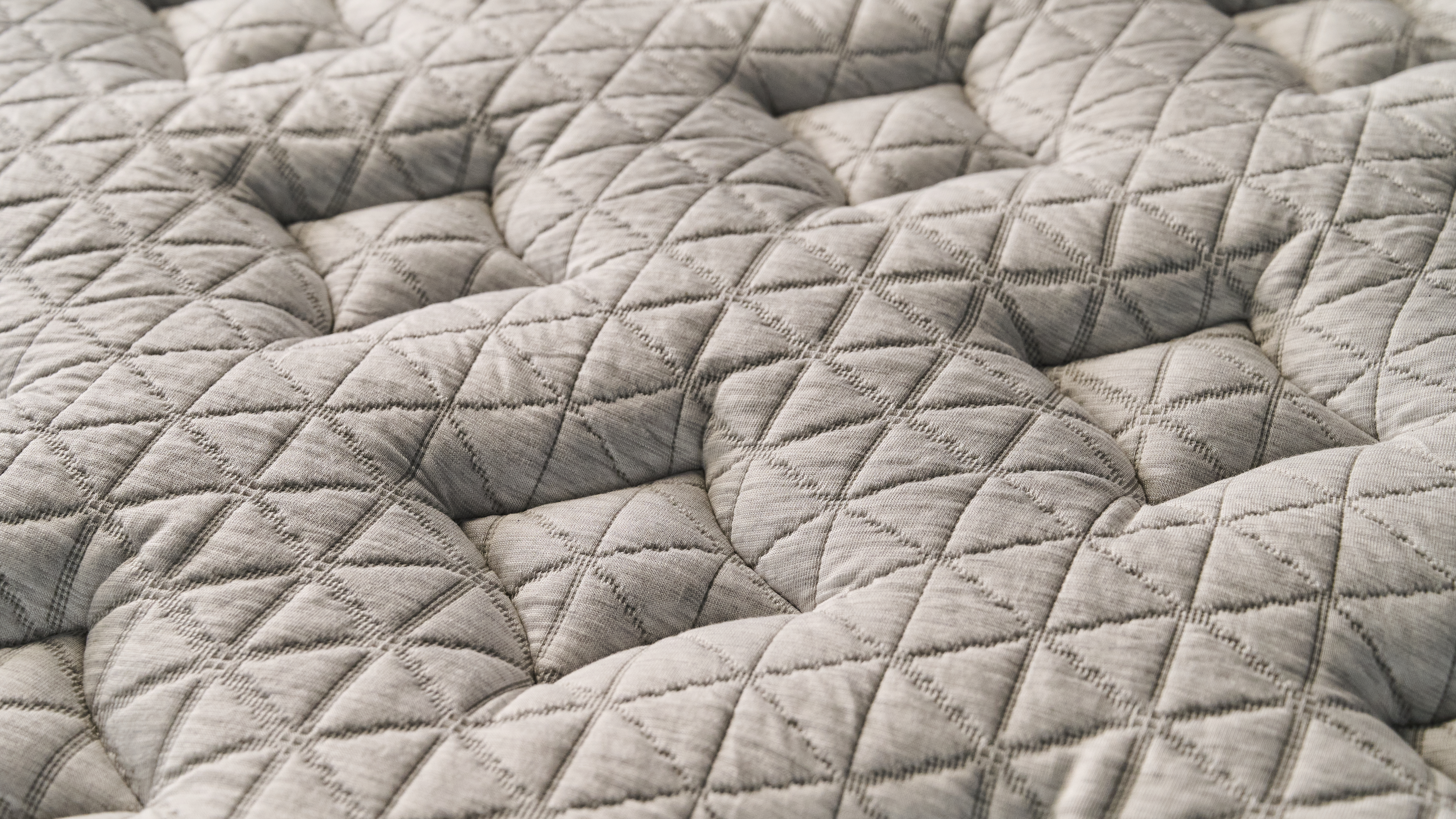 The image shows a close up of the diamond-stitched plush pillow top cover of the Helix Midnight Luxe mattress