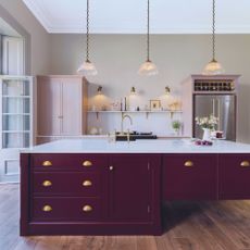 Harvey Jones traditional kitchen with dark red island and light pink cabinetry