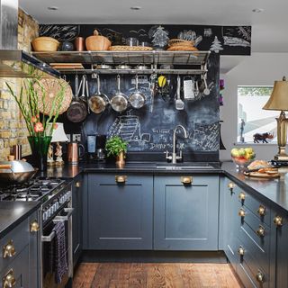 kitchen with blue cabinets and chalkboard wall