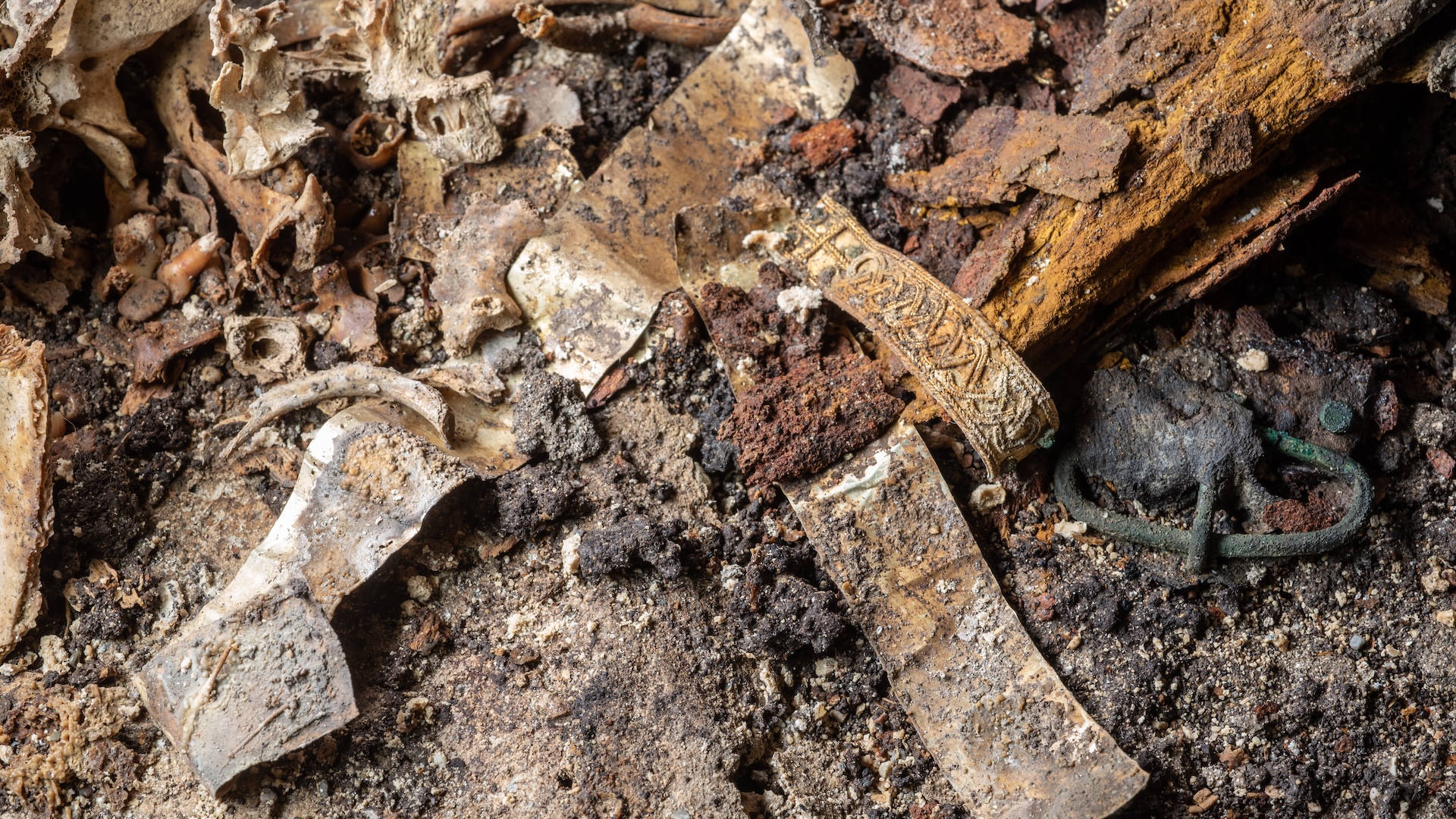 a close-up of a rusted sword in the dirt