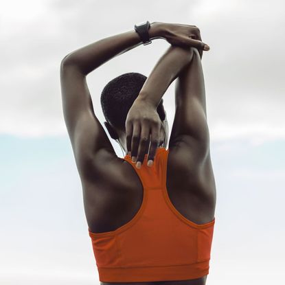 Back workout: A woman stretching her arms