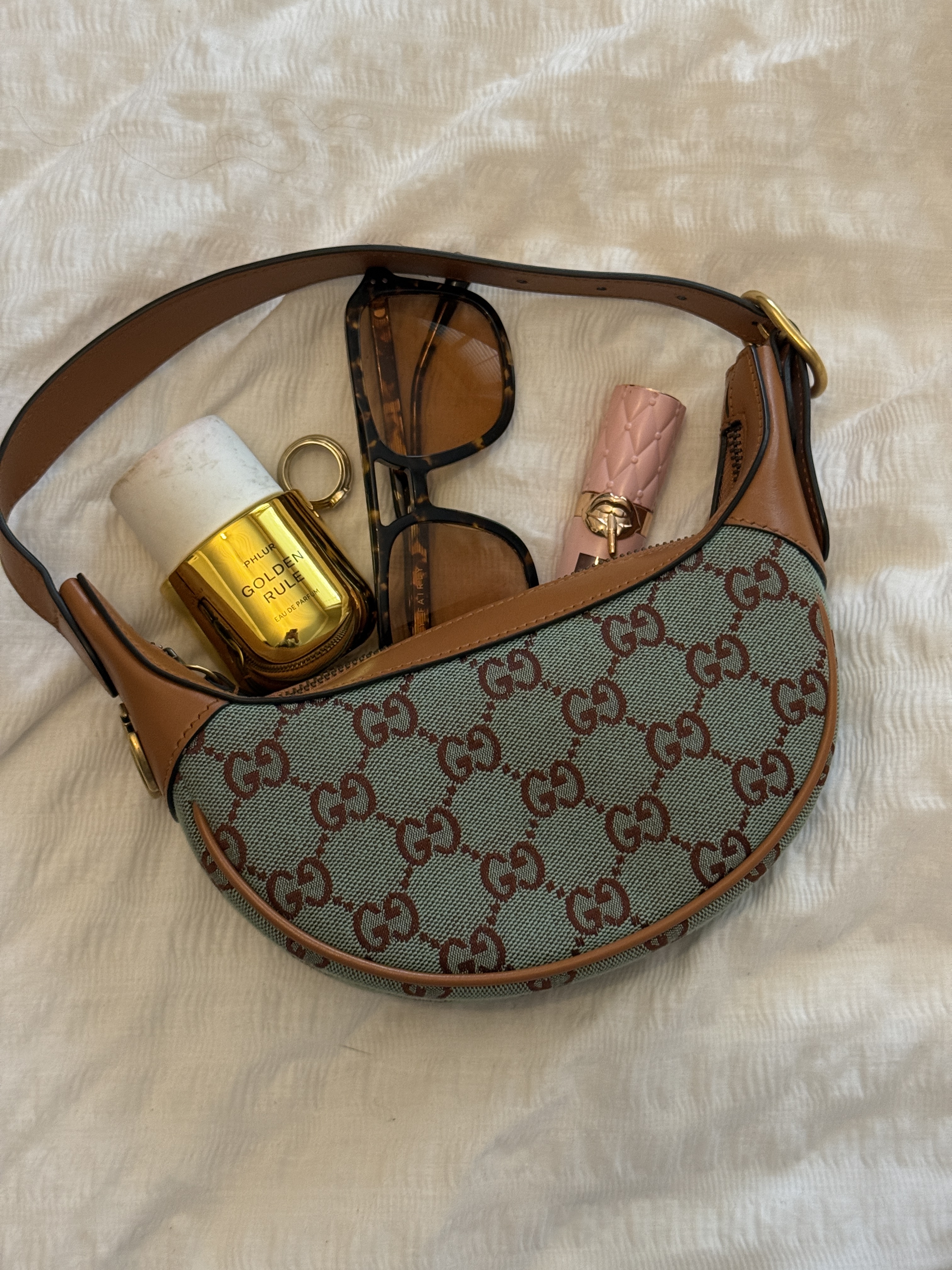Gucci bag, perfume, sunglasses and lipgloss