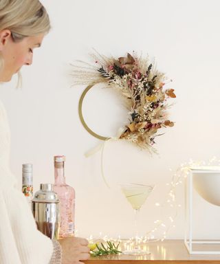 a dried flower and pampas grass Christmas wreath on a white wall