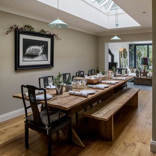 dining area with roof lantern and wooden flooring