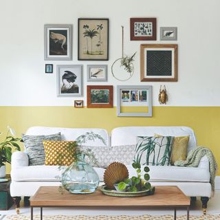A living room with a gallery wall and a two-tone wall