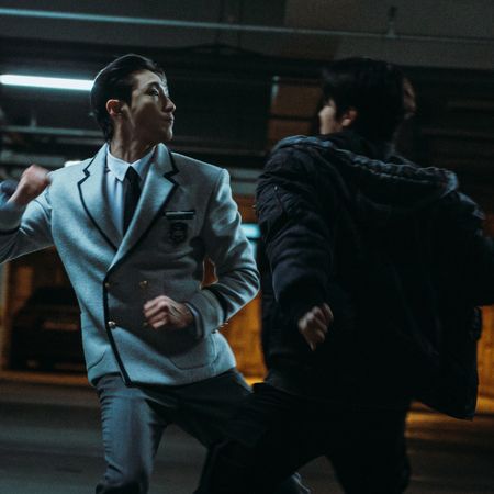 Two men (Bae Na-ra as Na Baekjin, Ryeo Un as Park Humin) fight in a parking garage in Weak Hero Class 2
