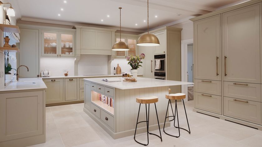 cream Shaker kitchen with large kitchen island with seating and stone flooring
