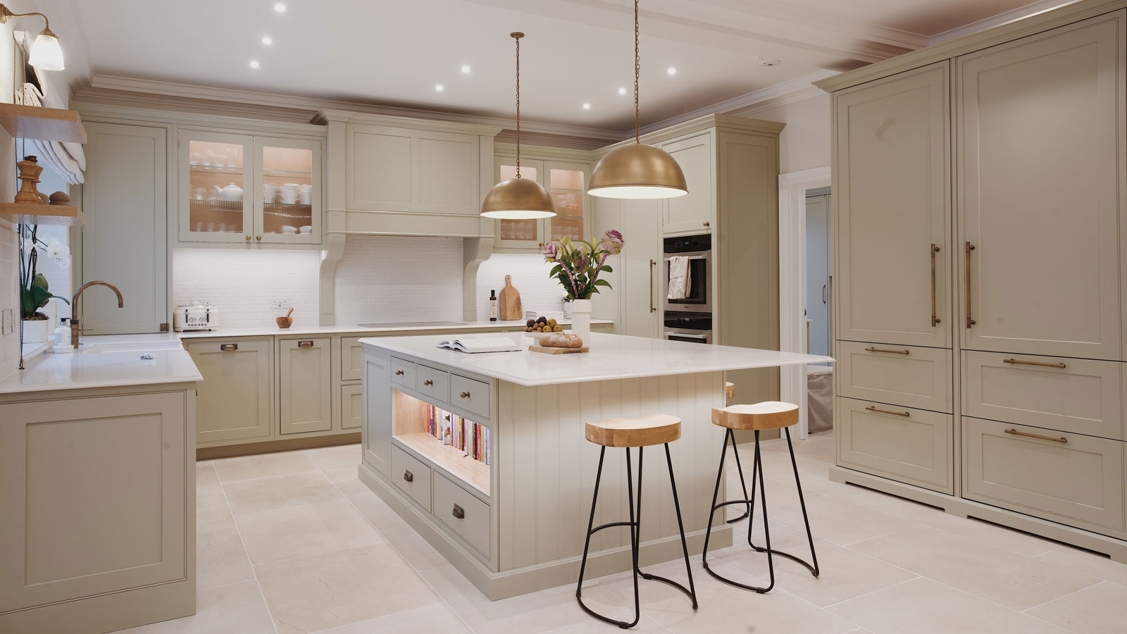 cream Shaker kitchen with large kitchen island with seating and stone flooring