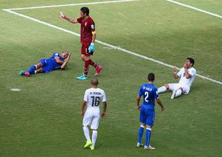 NATAL, BRAZIL - JUNE 24: Luis Suarez of Uruguay and Giorgio Chiellini of Italy react after a clash during the 2014 FIFA World Cup Brazil Group D match between Italy and Uruguay at Estadio das Dunas on June 24, 2014 in Natal, Brazil. (Photo by Julian Finney/Getty Images)