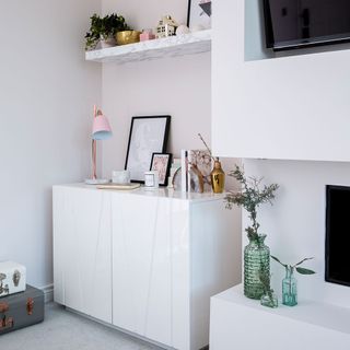 white living room with white marble cupboard and wall mounted shelf with accessories