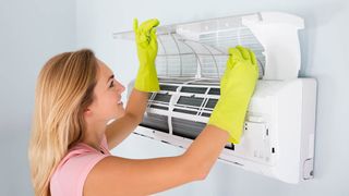 Woman opening up an air conditioner
