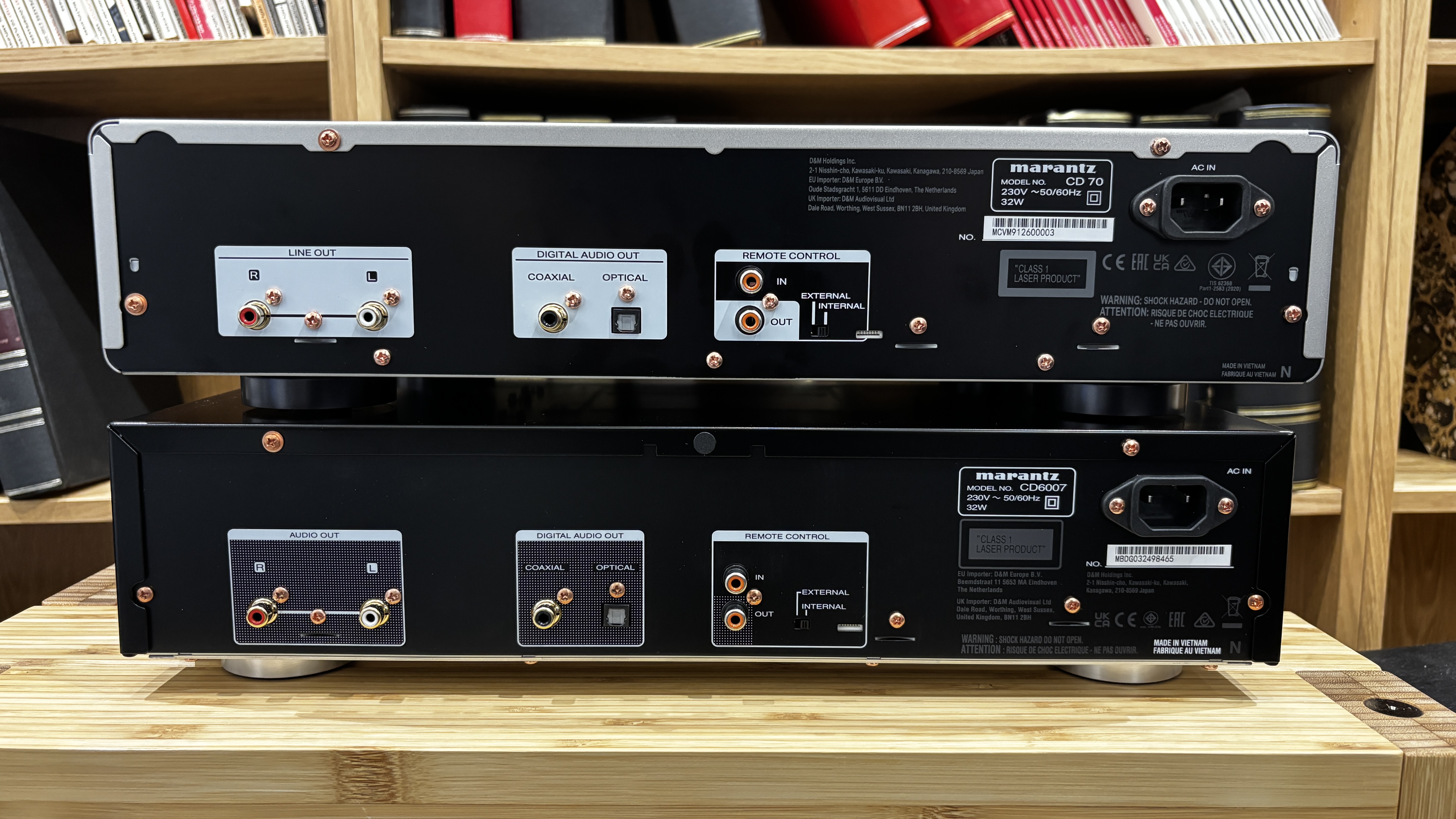 The back of a Marantz CD 70 and CD6007 stacked on a hi-fi rack showing all their connections