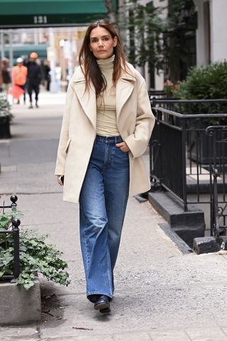 Katie Holmes spotted out and about wearing a butter yellow top coat and turtleneck with jeans from Banana Republic on October 03, 2024 in New York City