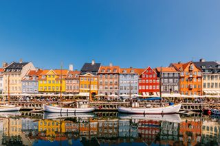 Multi-colored vibrant houses along Nyhavn harbour in Copenhagen, Denmark