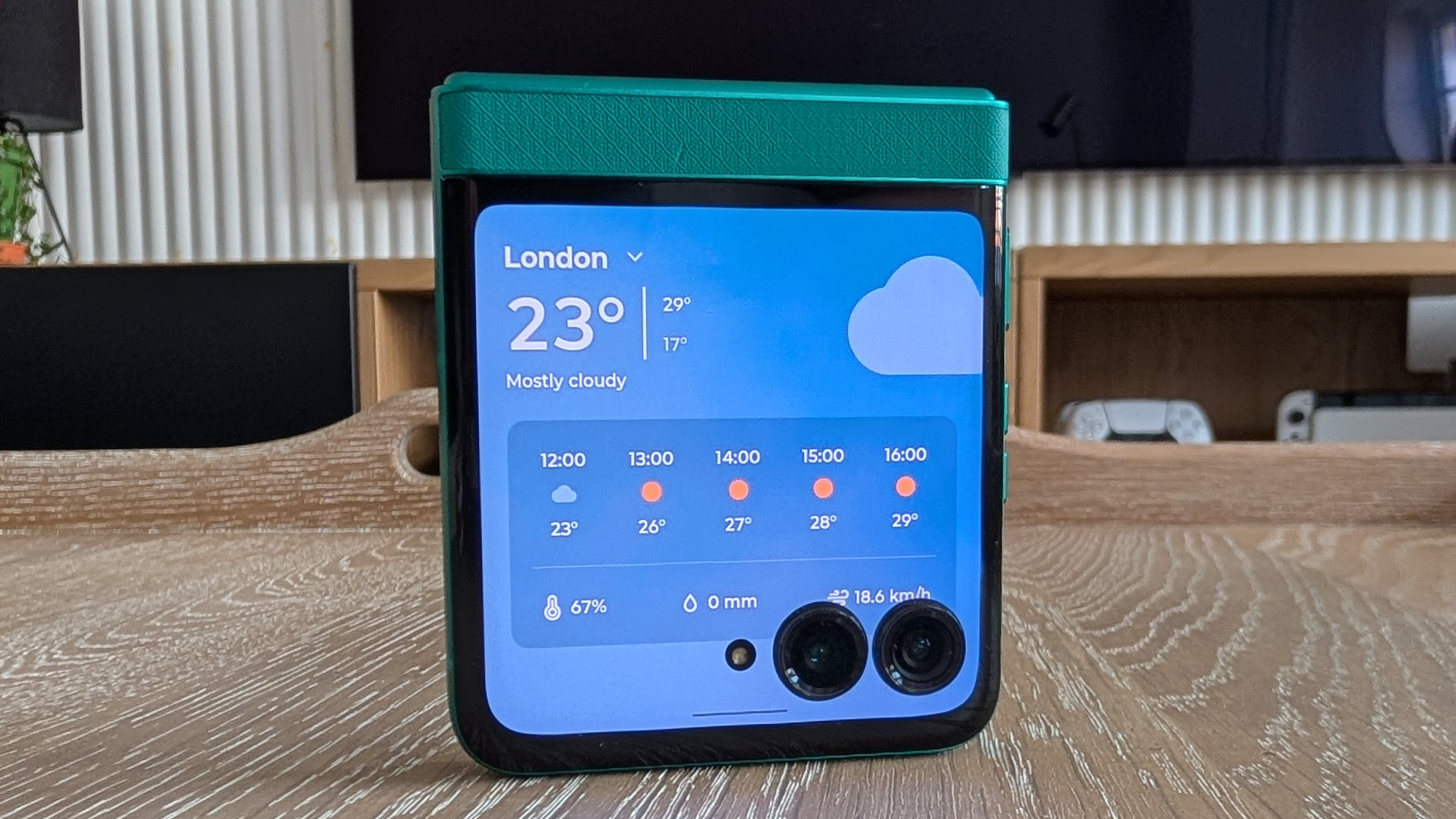 Motorola Razr 2026 in blue, being held in the hand