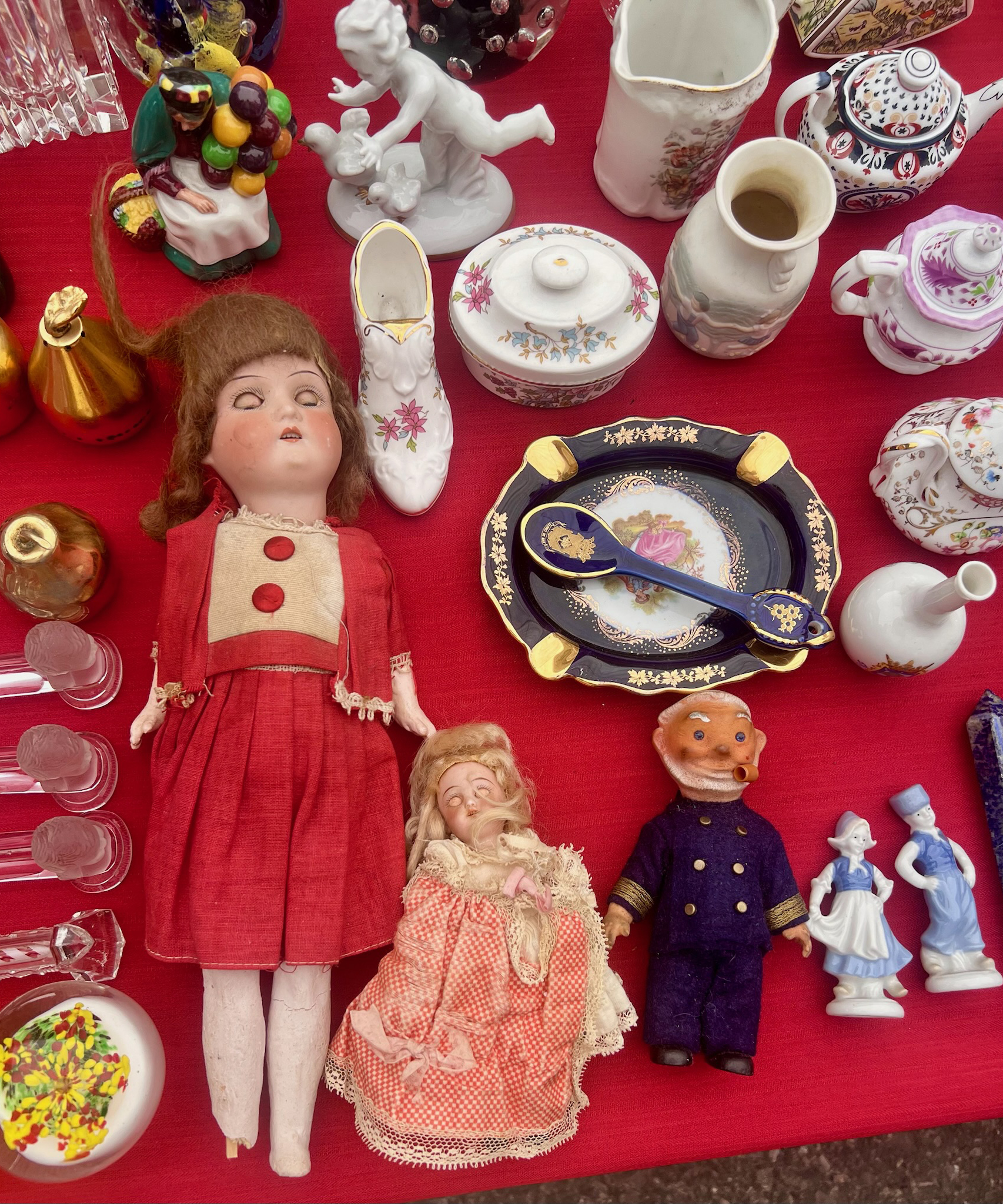market stall selling vintage dolls and china