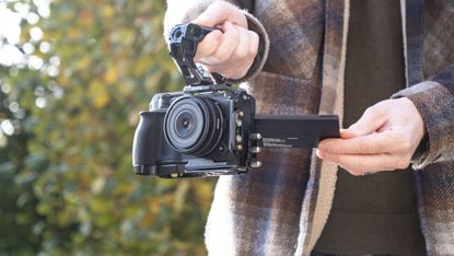 Nikon ZR product photos – inside a dedicated SmallRig cage, held by user