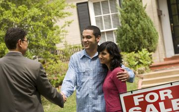 Home Owners Giving a Handshake to the Real Estate Agent