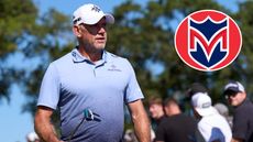 Lee Westwood walks off the green, with a Majesticks GC logo in the corner