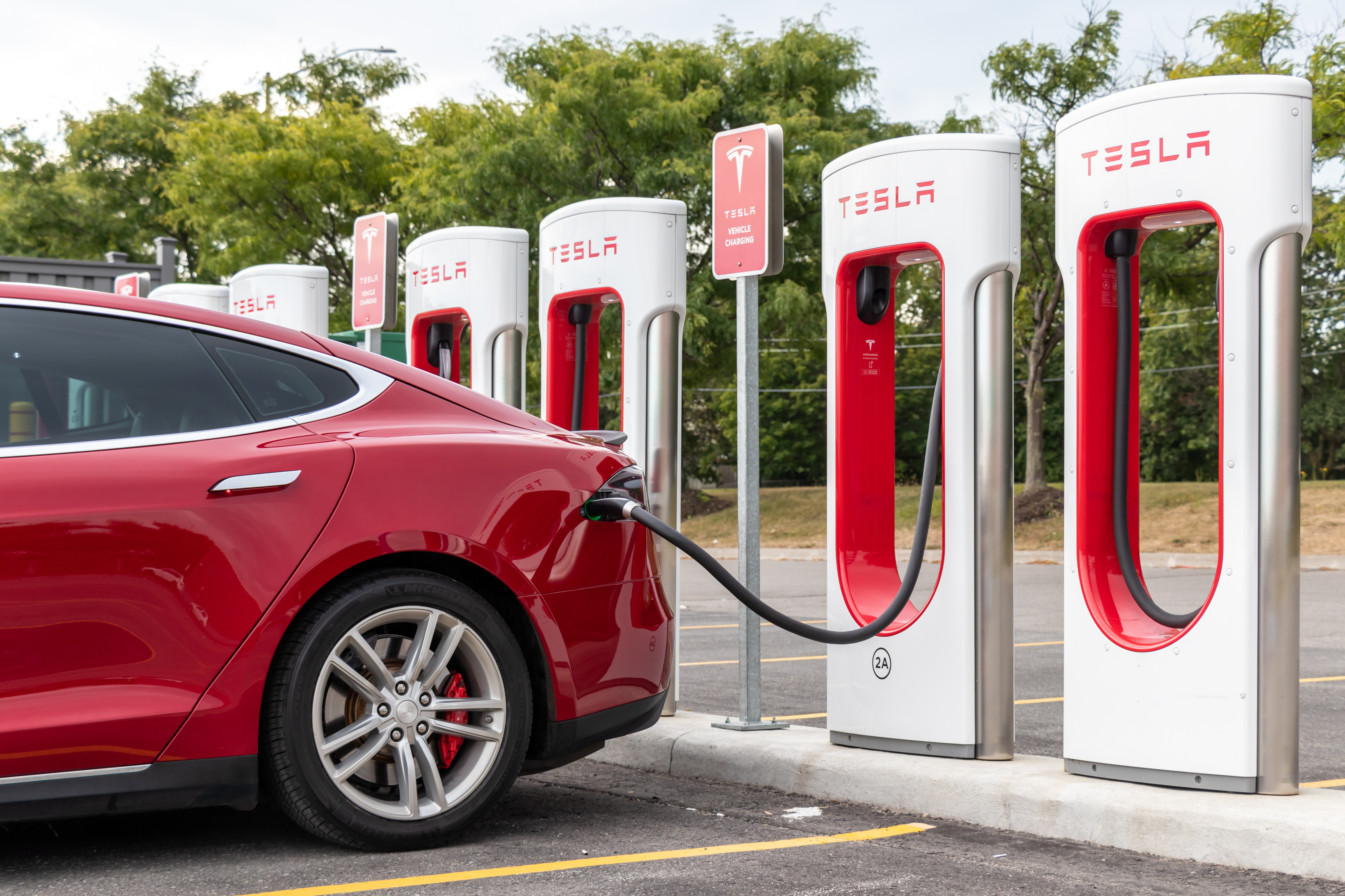 tesla model 3 at a supercharger station