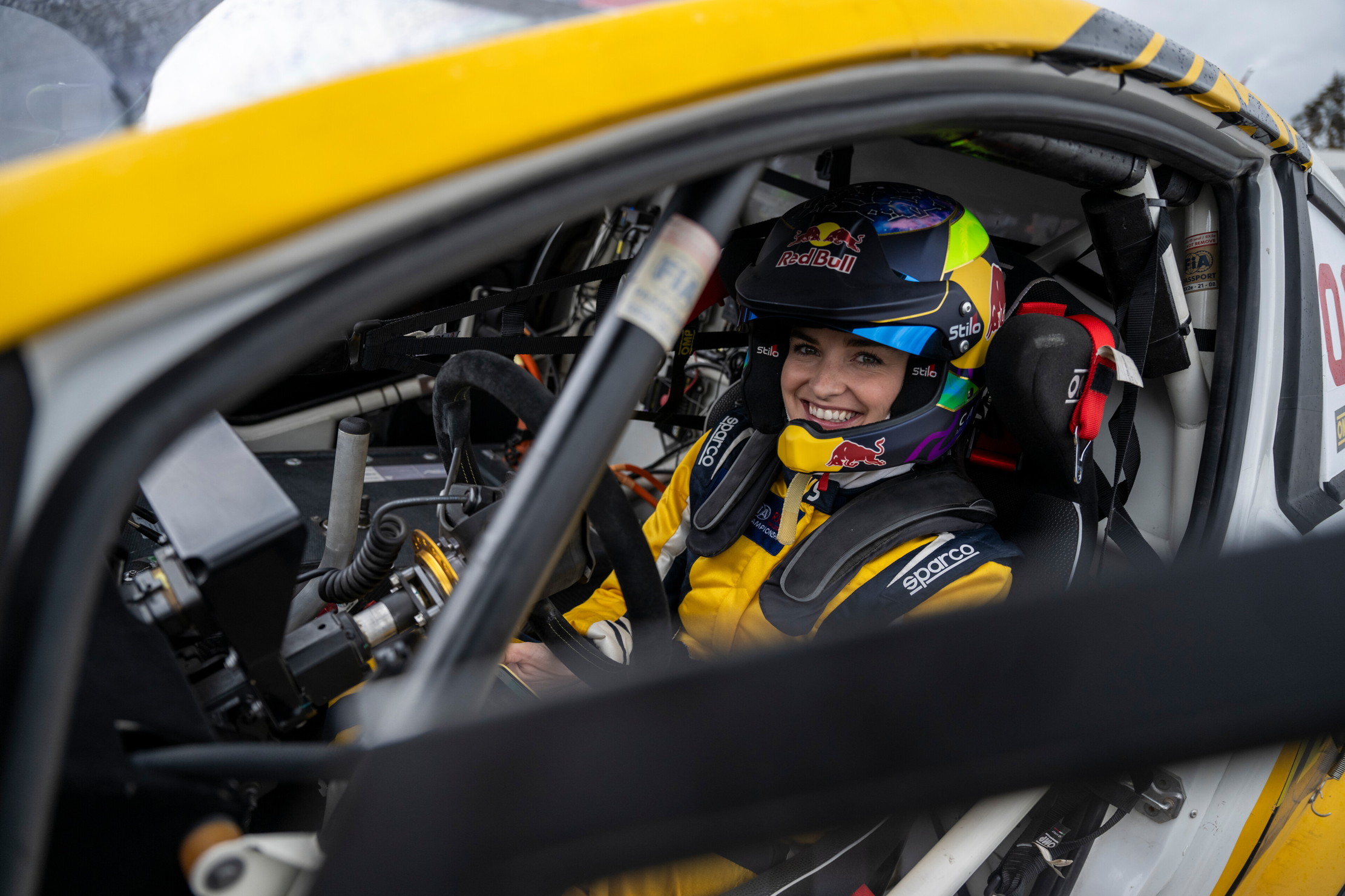 Catie Munnings strapped into a yellow racecar