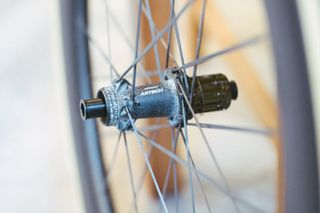 A close up of a black rear bike hub, showing many white patches of corrosion.