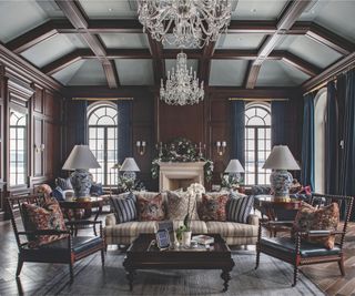 comfortable seating area with sofa and armchairs around coffee table and end tables with table lamps