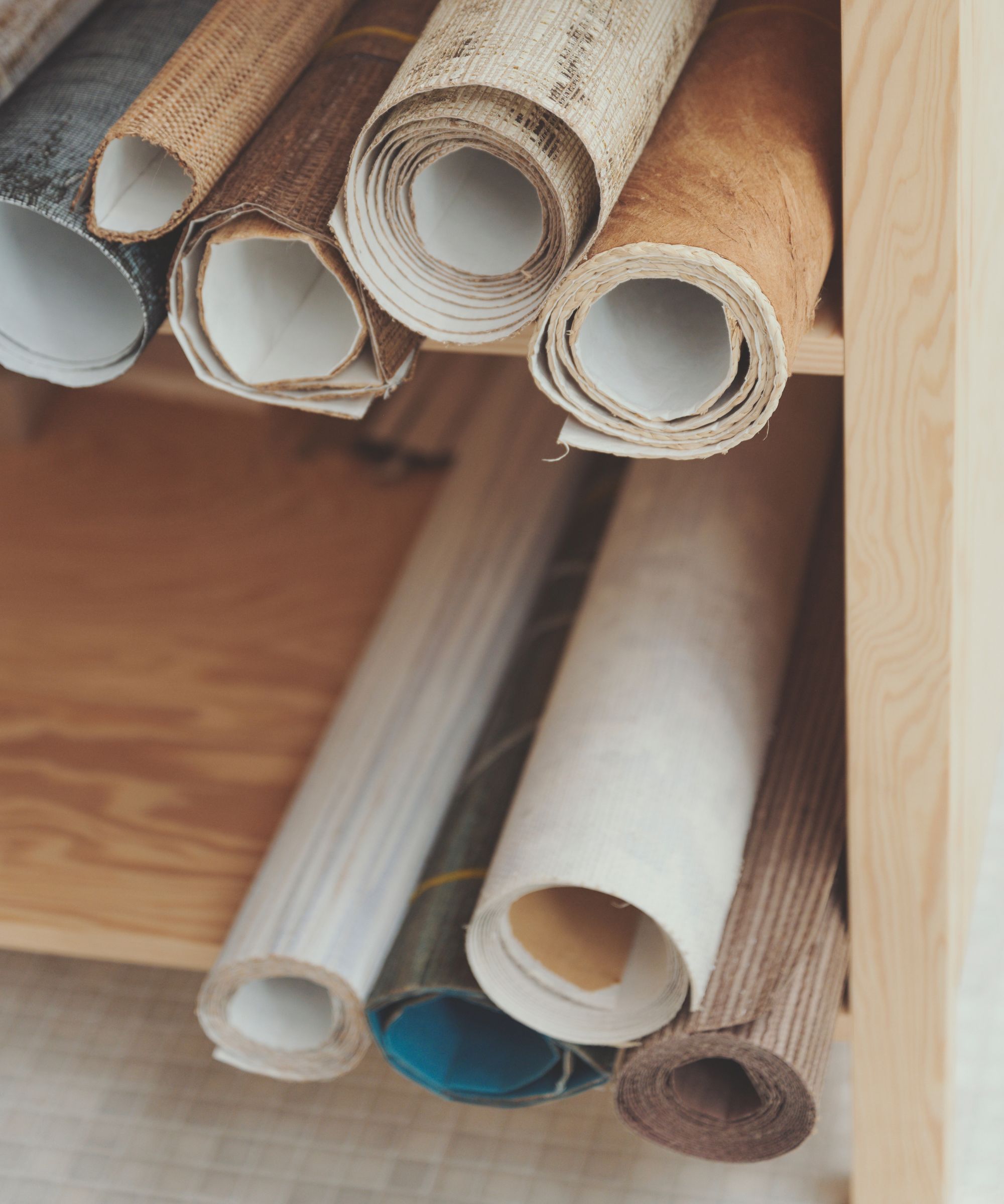 Rolls of wallpaper on a shelf