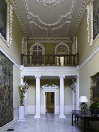 Crichel, Dorset: The vestibule originally incorporated the staircase of the 1740s house. Visible in the centre of the ceiling is part of a cartouche displaying the Napier coat of arms and crest