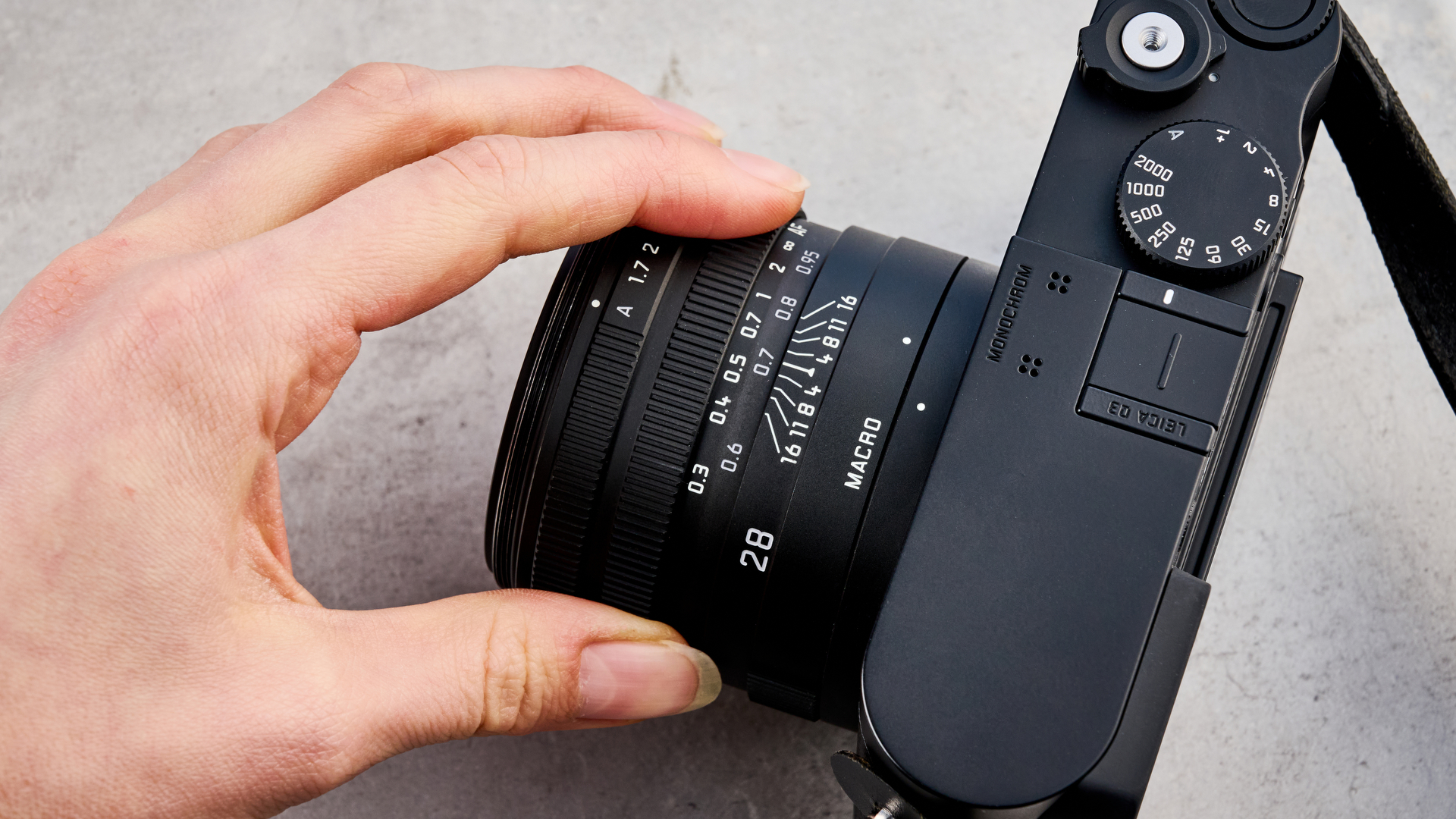 A black Leica Q3 Monochrom black-and-white mirrorless camera