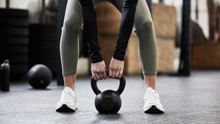 a photo of a woman holding a kettlebell