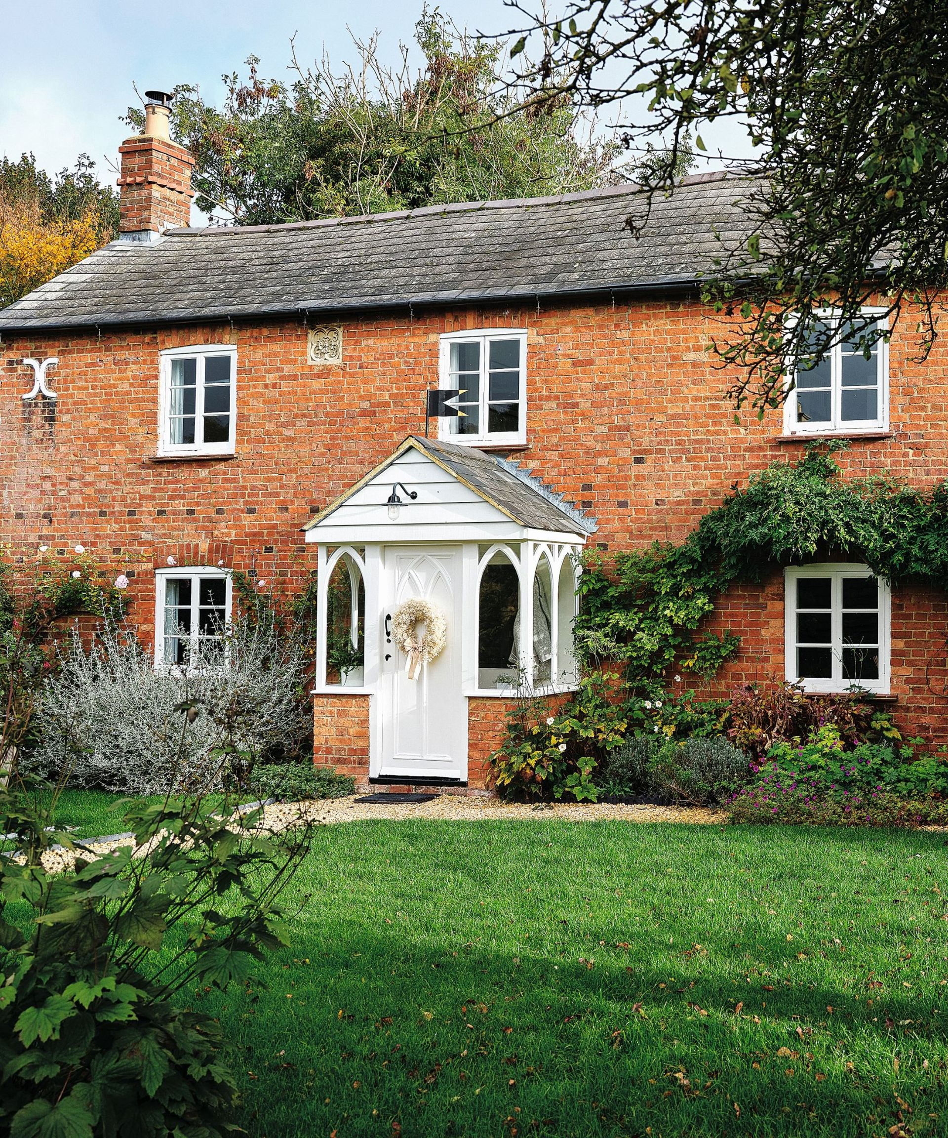 Brick house, white front door, wreath