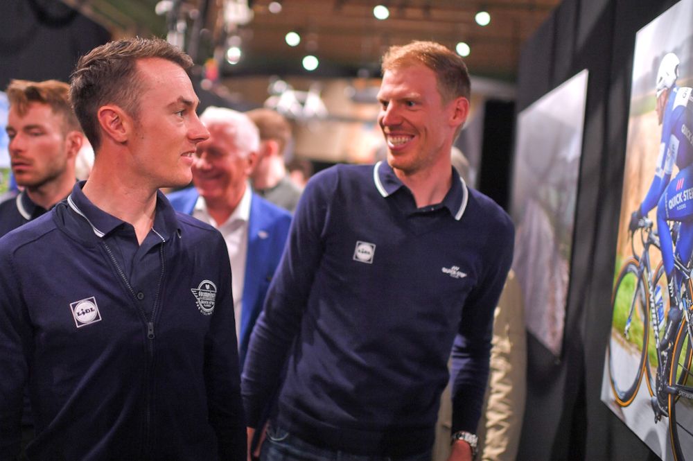 Yves Lampaert and Tim Declercq look at photos at the Deceuninck-QuickStep presentation