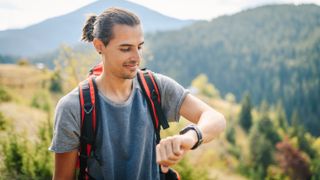 Hiker checking sports watch