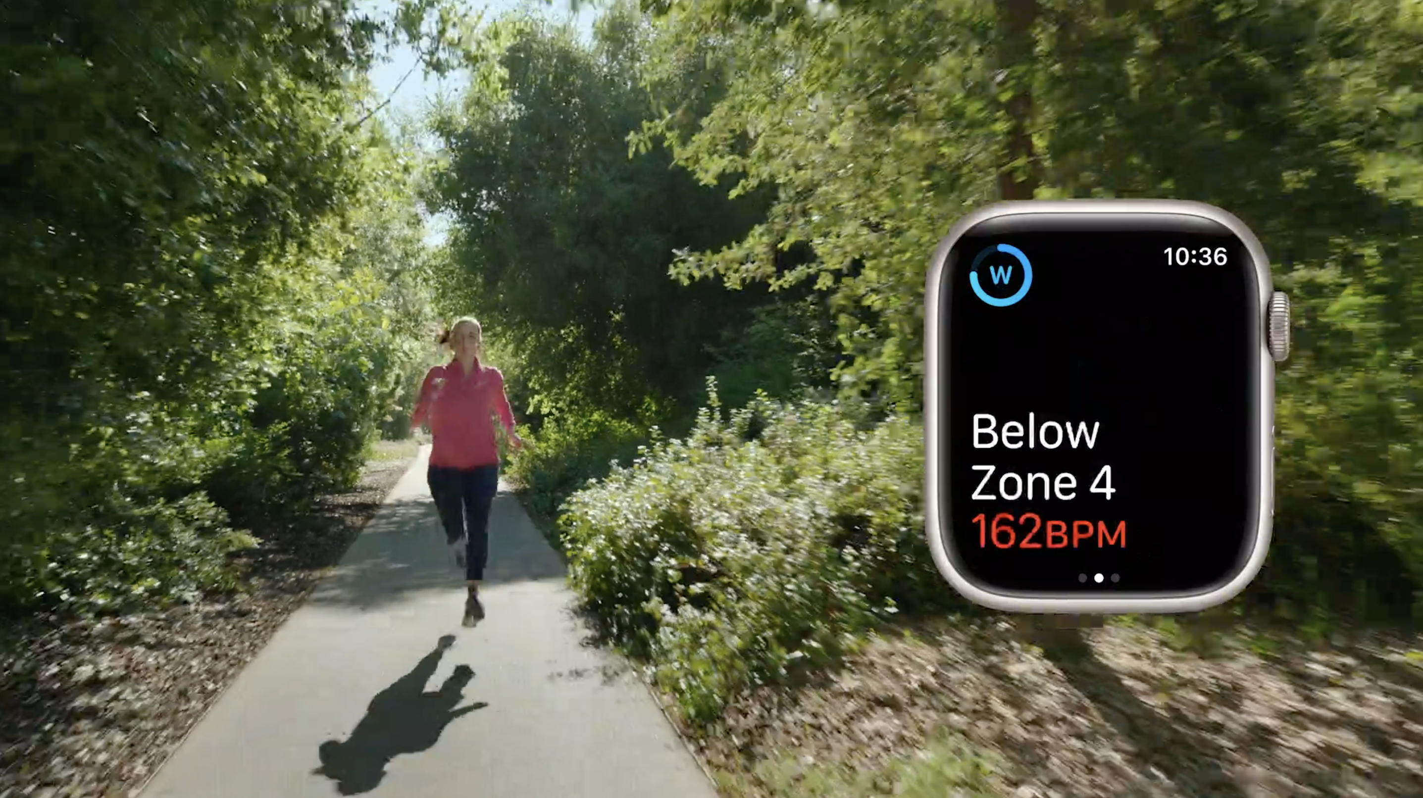 A runner seen alongside an image of watchOS 9 showing they're below zone 4