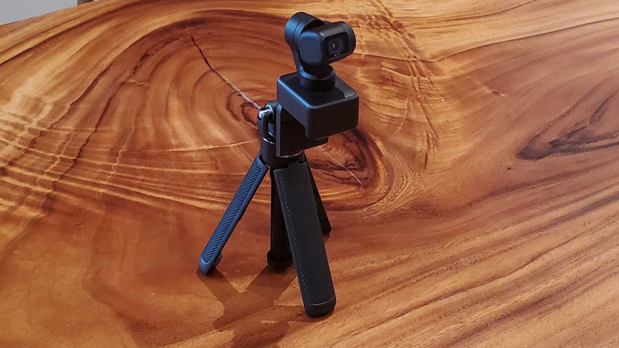 An Insta360 Link on a table with a tripod