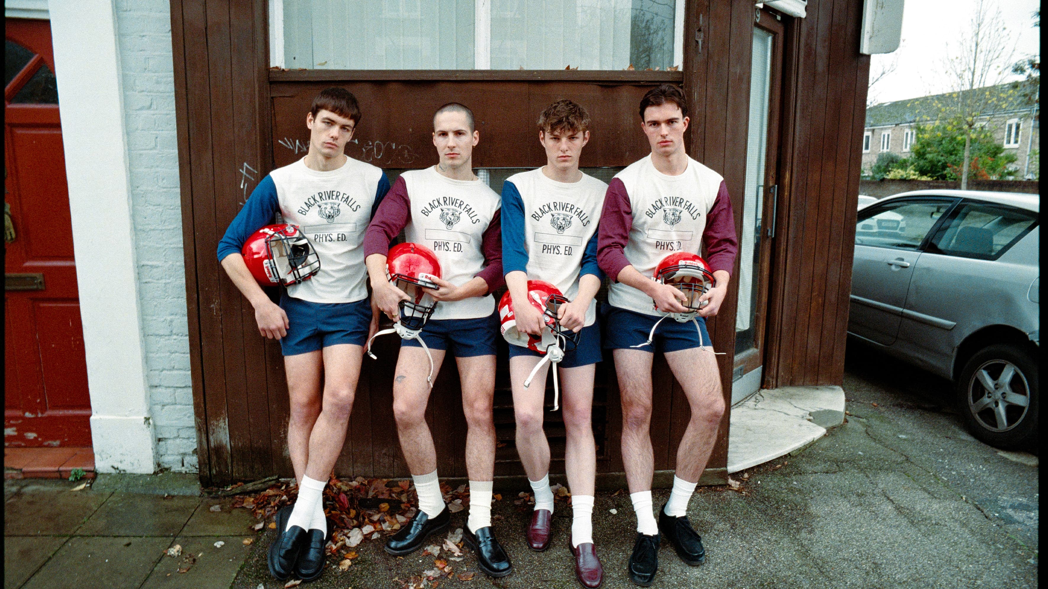 Four teenagers wearing American Footbal outfits.