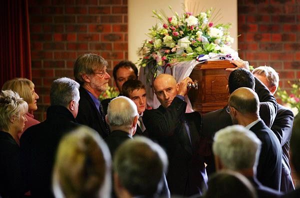 Amy Gillett's coffin is taken from the Chapel. (LtoR) Mary Safe, Denis Safe, Rhys Gillett, Simon Gillett