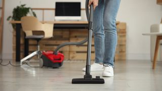 Person vacuum cleaning floor