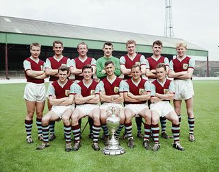The Burnley Division One championship winning squad of season 1959-60 pose with the trophy at Turf Moor, Burnley, England, selected players include Ray Pointer (back row right)John Connelly (front row left) Jimmy McIlroy (front row second left) Jimmy Adamson (front row centre)