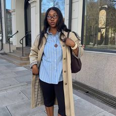 Woman Wearing Blue Button Down and Trench Coat