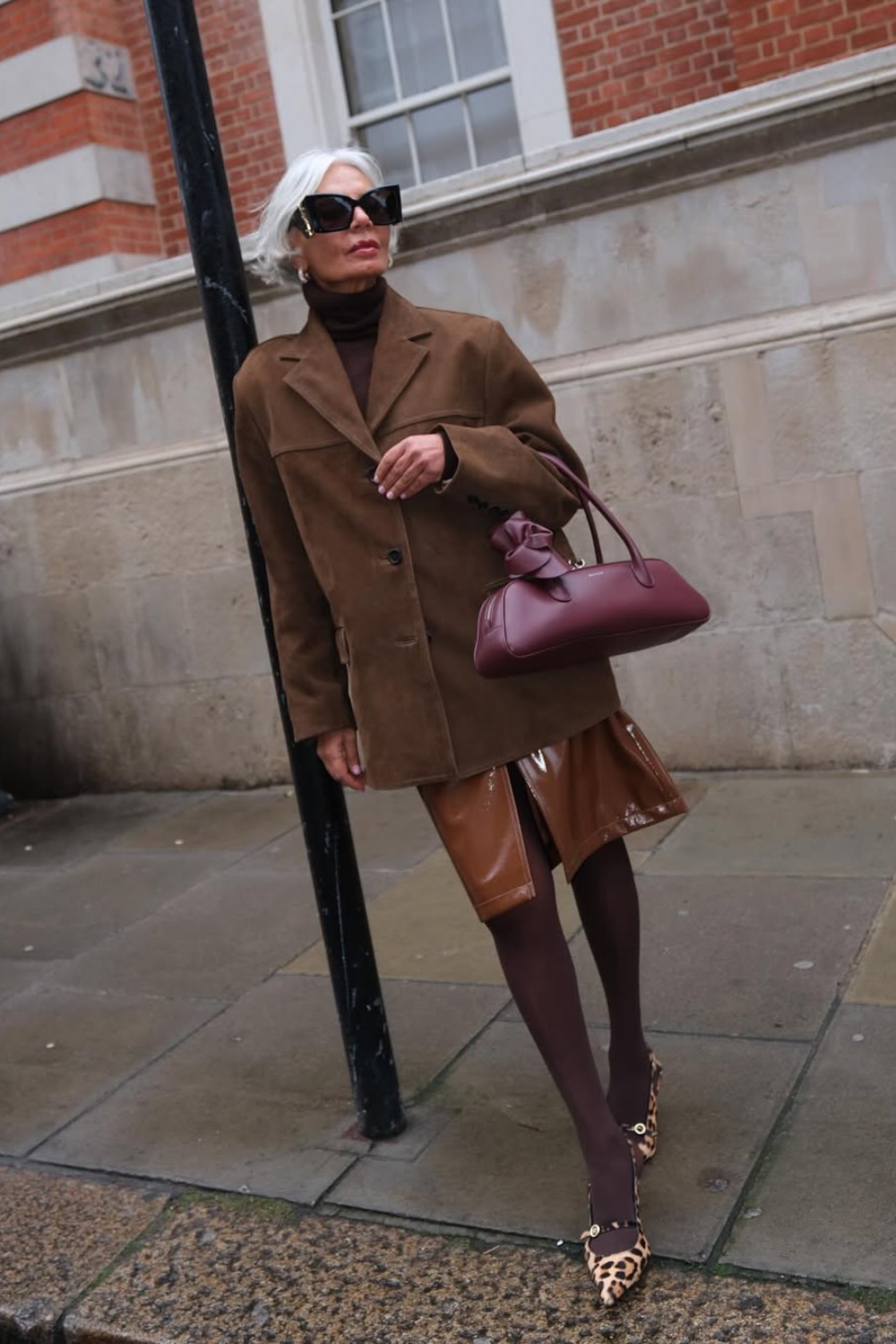 @greceghanem wears brown suede jacket, skirt, tights